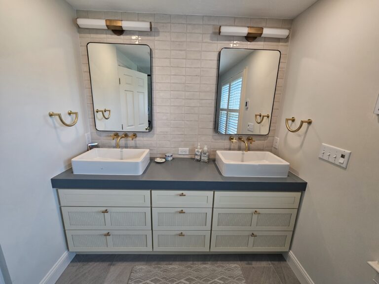 Double sink vanity with soft brass fixtures in new location - Plymouth, MA